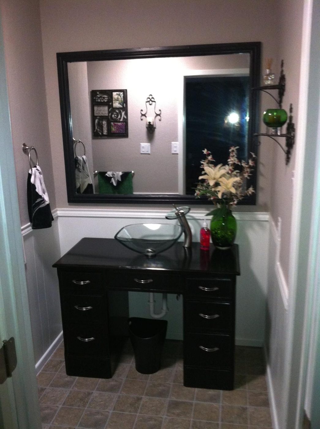 Powder room with vessel sink and painted vanity